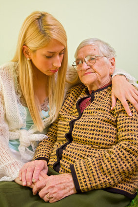 Granddaughter comforting grandmother with Alzheimers