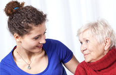 younger woman with hand on seniors shoulder